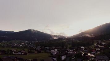 A village in the mountains with a sun setting video
