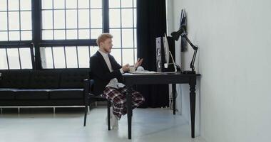 A man sitting at a desk in front of a window video