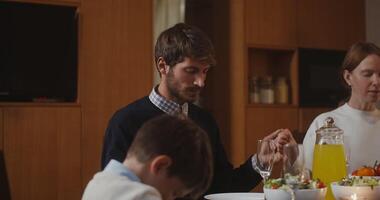 A family is eating dinner together at a table video