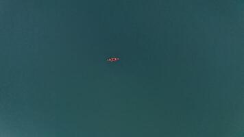 A small boat is floating in the middle of the ocean video