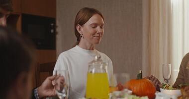 A family is sitting at a table with food video