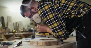 A man is using a power tool to make a piece of wood video