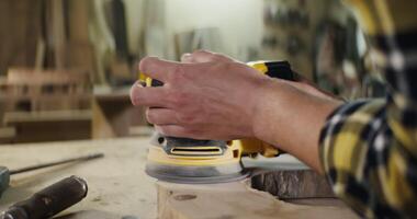 A person is using a sander on a wooden surface video