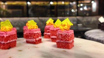 Delightful pink cakes being showcased in a stylish cafe setting video