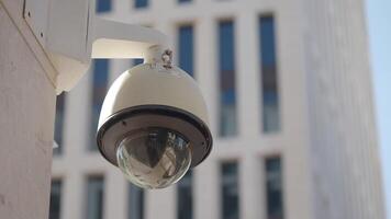 Security camera monitors busy urban area during daylight hours video