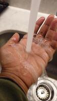 Water running from faucet into open hand during a clean moment video
