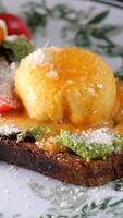 Delicious poached egg on avocado toast served in cozy cafe setting video