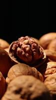 Walnut nuts food, closeup of walnut nut texture on black background, vertical walnut video
