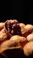 Walnut nuts food, closeup of walnut nut texture on black background, nuts food video