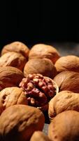 Walnut nuts food, closeup of walnut nut texture on black background, vertical of nut video