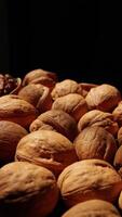 Walnut nuts food, closeup of walnut nut texture on black background, brown walnut on black video