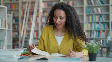 Latina Caucasian Hispanic woman reading favorite book novel interested female plot twist girl student knowledge development learning enthusiastic work hobby library university smiling excited reader video