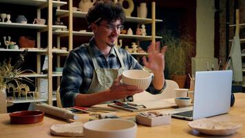 Potter man Caucasian guy online class pottery workshop male blogger craftsman artist designer sculptor holding bowl clay modeling handmade teaching ceramics crafting call tutorial lesson laptop video