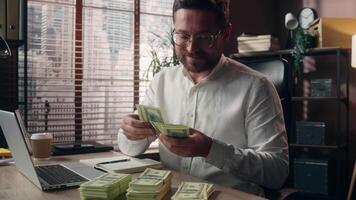 Glad positive Caucasian executive man accountant male worker company leader agent calculate dollars cash in office businessman entrepreneur guy counting salary banknotes money business expense earning video