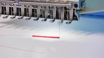 Automatic professional embroidery machine. Automatic embroidery machine working at high speed in factory video