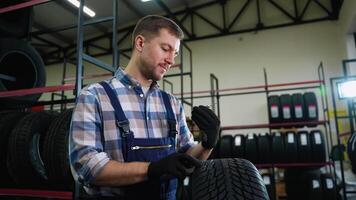 Tire store worker measuring tread depth with gauge video