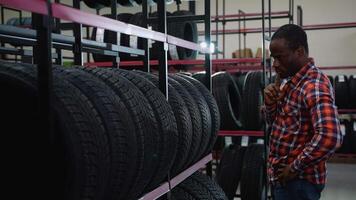 Customer selecting tires in an automotive store aisle video