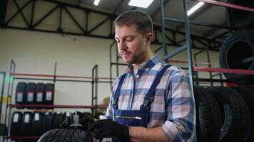 Tire store worker checking tread depth with gauge video