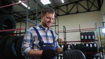 Smiling tire store worker measuring tread depth with gauge video