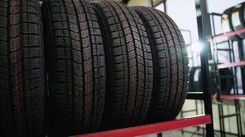 Winter tires with deep tread pattern displayed on store rack video