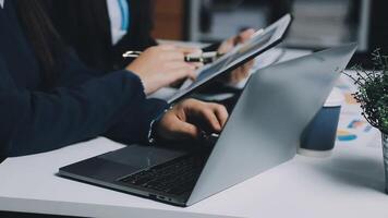 Two people working on a laptop at a desk video