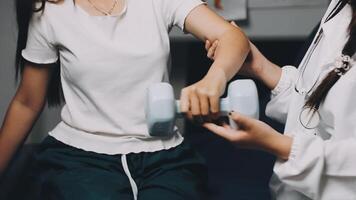A woman is doing exercises with a dumbbell video