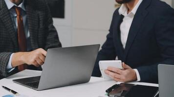 Two business people are working on a laptop video