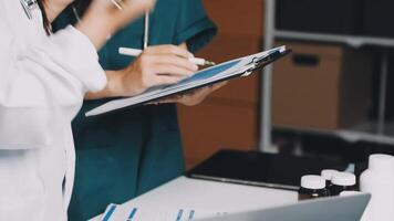 Two doctors are working on a clipboard video