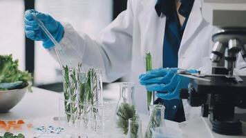 A person in a lab coat is holding a test tube video