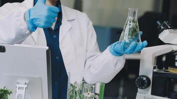 A man in a lab coat is holding up a glass of water video