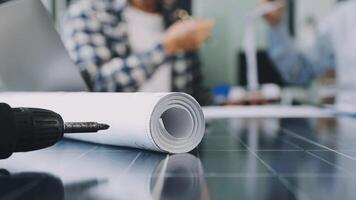 A man is working on a project with a roll of paper video