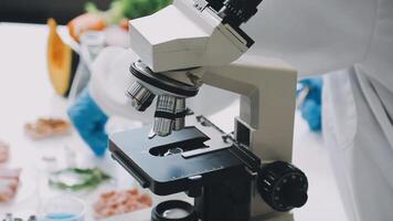 A person in a lab coat is looking at a microscope video