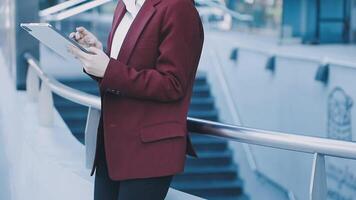 A woman in a business suit is standing on a railing video