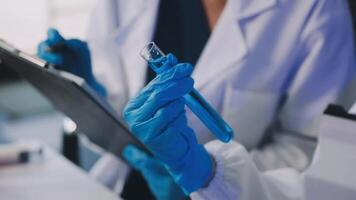A person in a lab coat holding a clipboard video