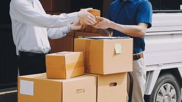 Two men are holding boxes and one is handing them to another video
