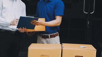 Two men are holding boxes and one is holding a clipboard video