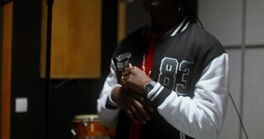 A man in a recording studio with a microphone video