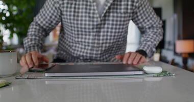 A man is using a laptop on a table video