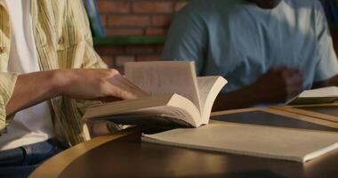 A person is reading a book at a table video