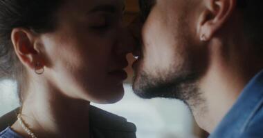 A man and woman kissing in front of a window video
