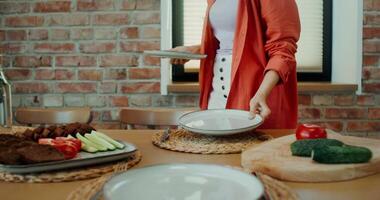 A woman is standing in front of a table with plates of food video