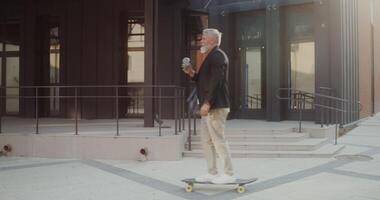 A man on a skateboard in front of a building video