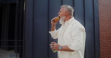 A man with a beard eating a sandwich video