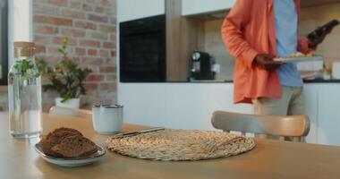 A man standing in front of a table with a plate of food video