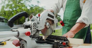 A man is using a circular saw to cut wood video