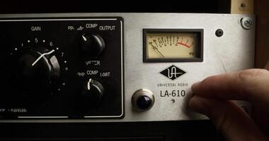 A person is adjusting the dial on a radio. Universal Audio Radio video