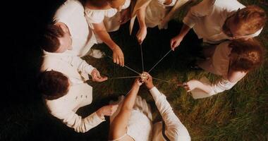 Top view of the guests lighting sparklers and start dancing with them around the bride and groom video