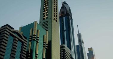 Modern glass skyscrapers of unusual shapes with sunlight reflected in it video