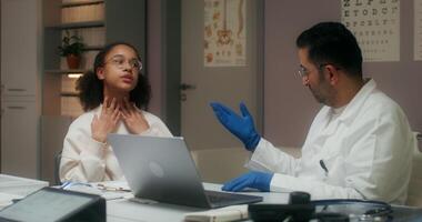 A woman is talking to a doctor while sitting at a desk video