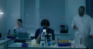 A group of people in a lab with a laptop video